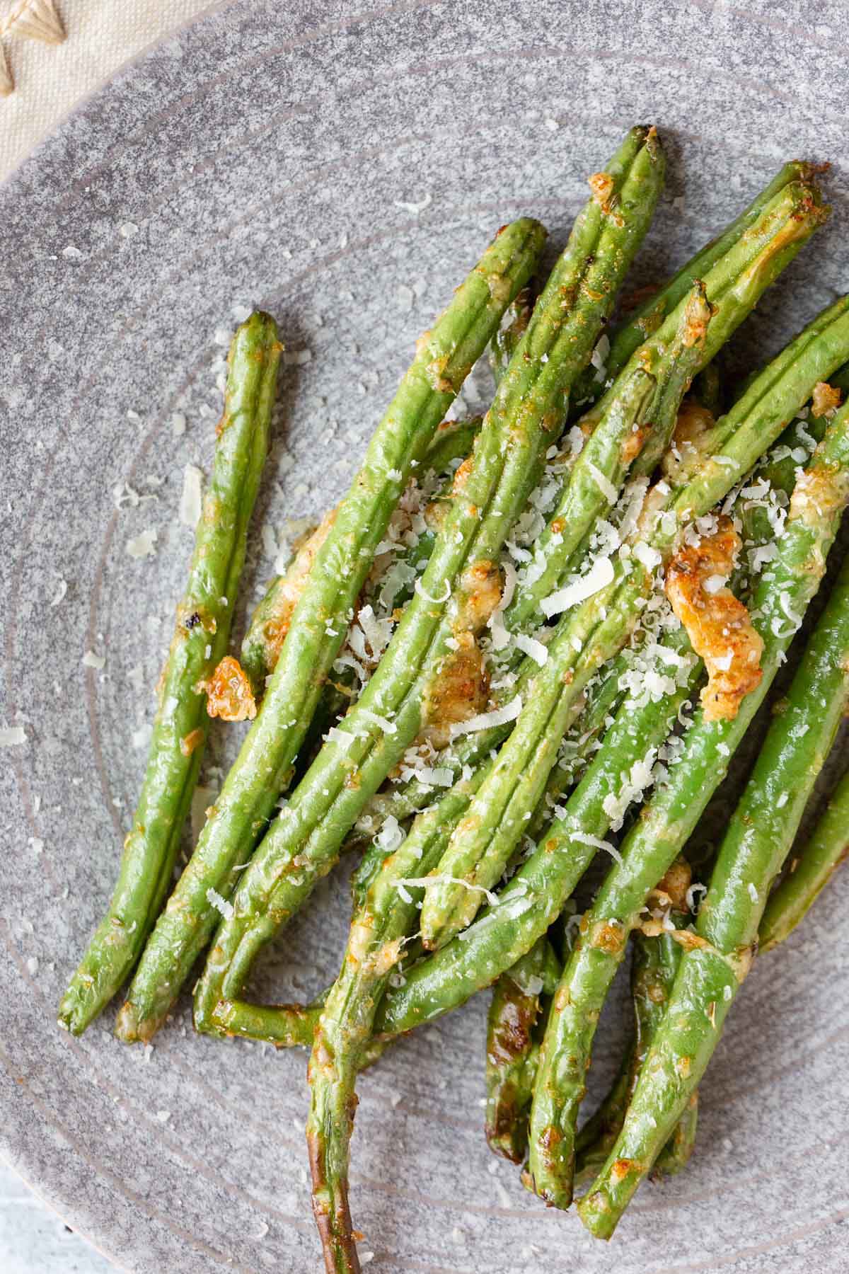 Cooked green beans on a plate.