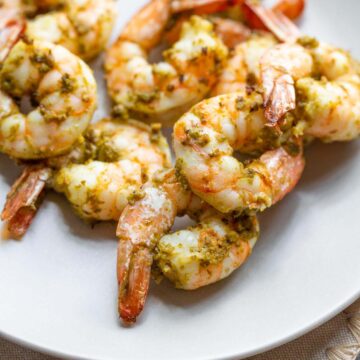 Pesto shrimp on a plate.