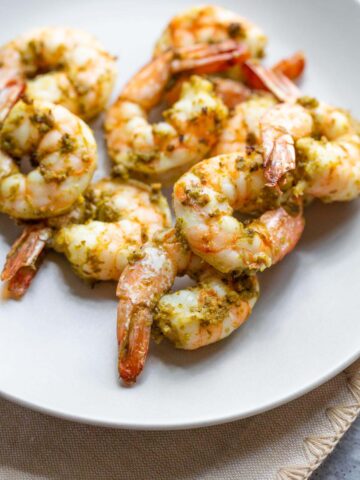 Pesto shrimp on a plate.