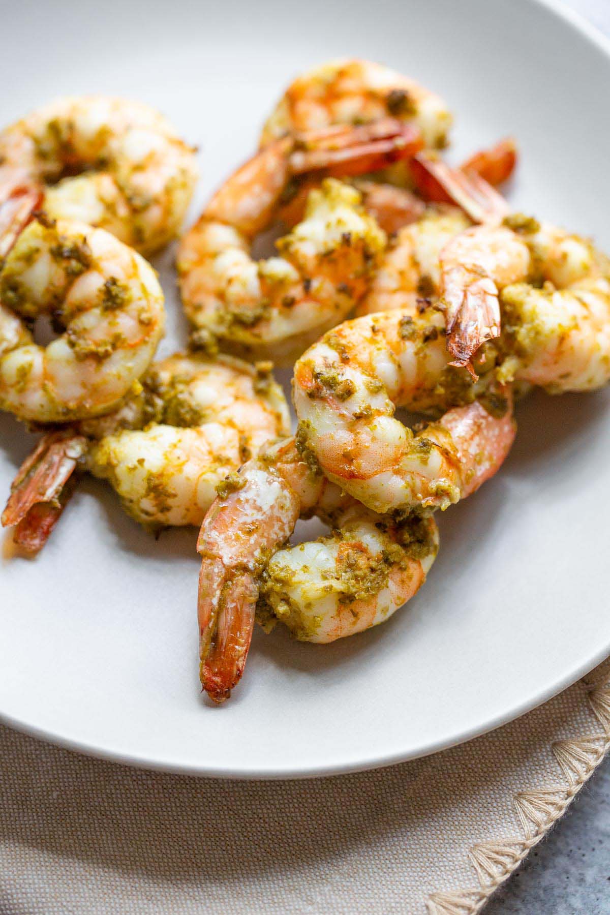 Pesto shrimp on a plate.