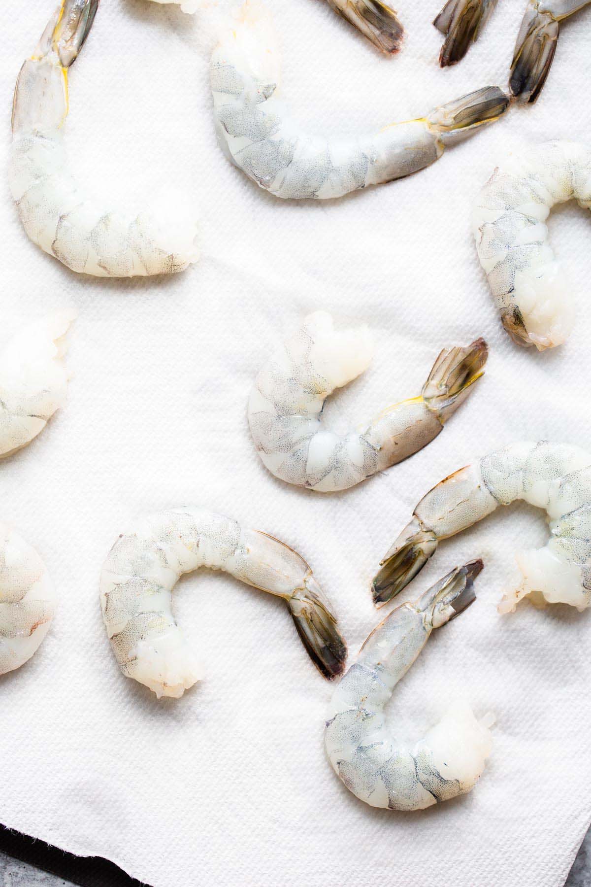 Uncooked shrimp on paper towels.