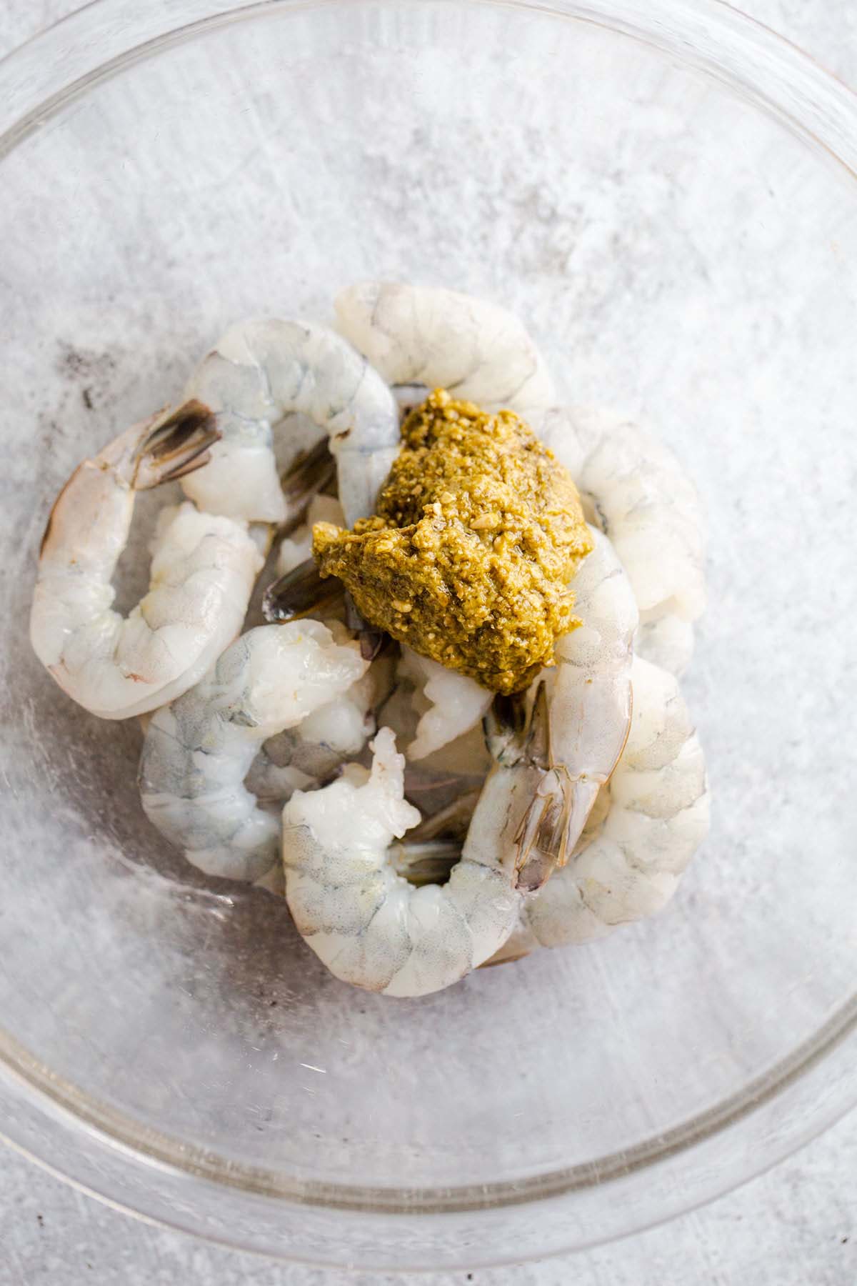 Shrimp and pesto in a bowl.