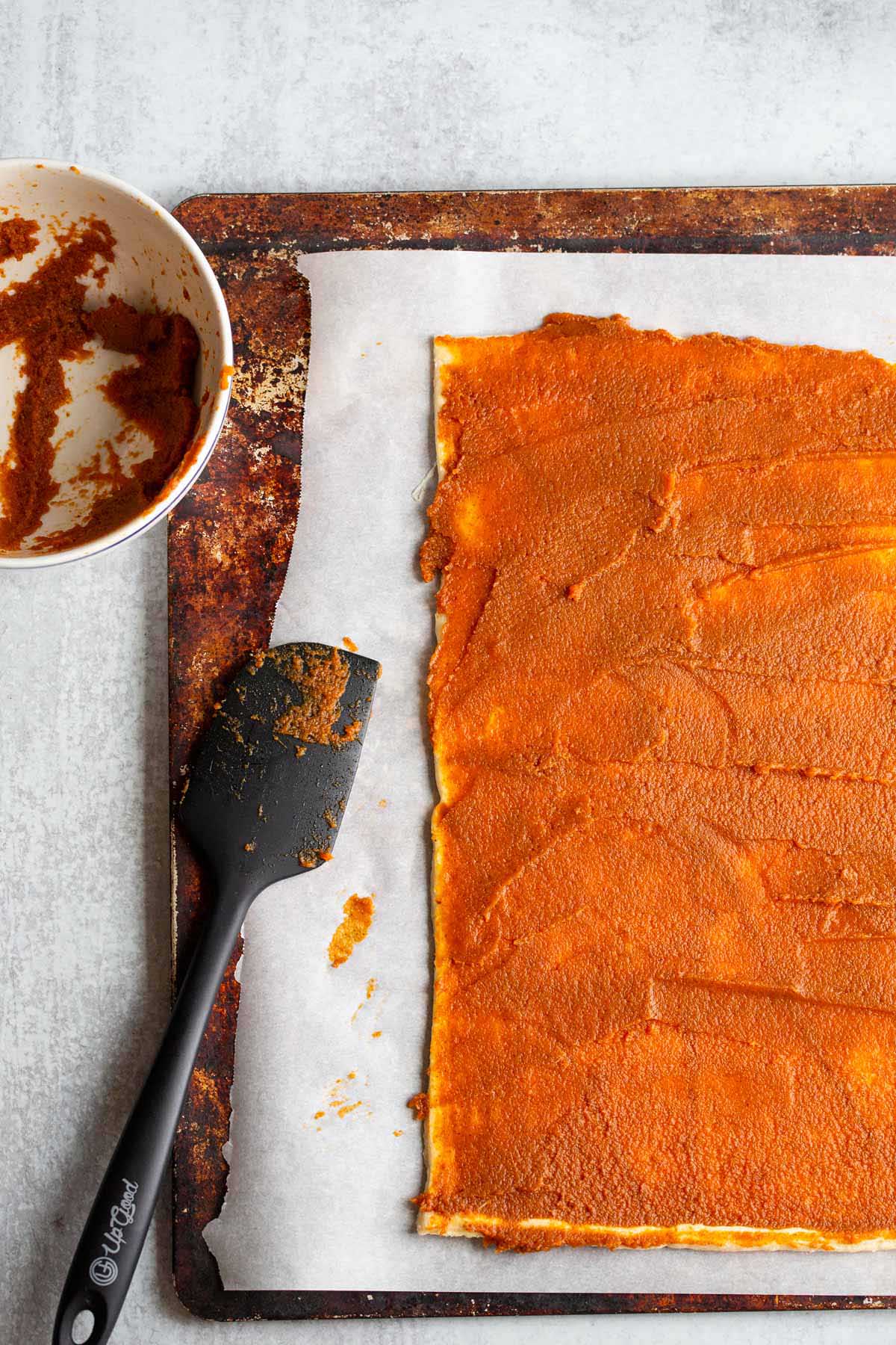 Pumpkin filling spread onto crescent rolls.