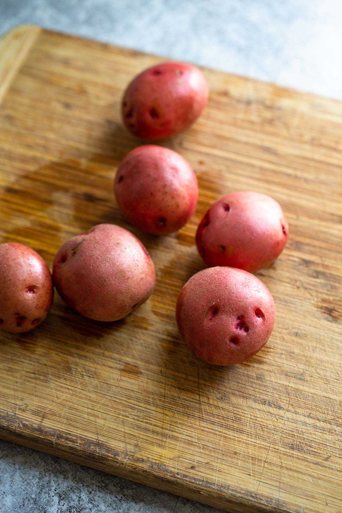 red potatoes on a cutting board.