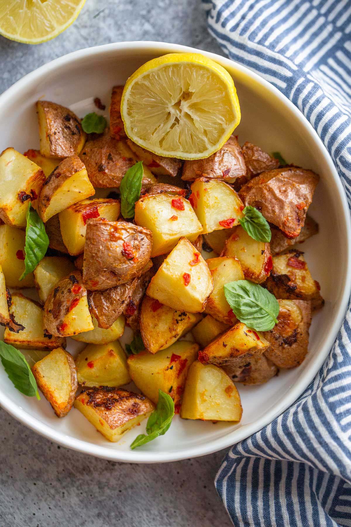 calabrian potatoes in a bowl with half a lemon.