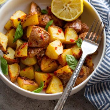 calabrian potatoes in a bowl with half a lemon.