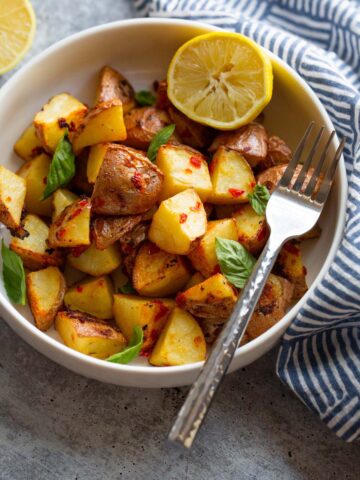 calabrian potatoes in a bowl with half a lemon.