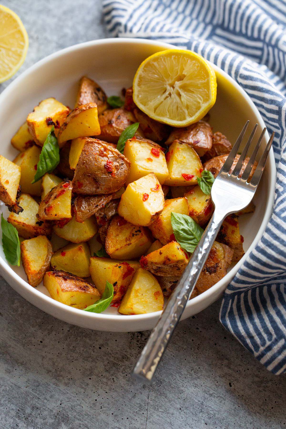 calabrian potatoes in a bowl with half a lemon.