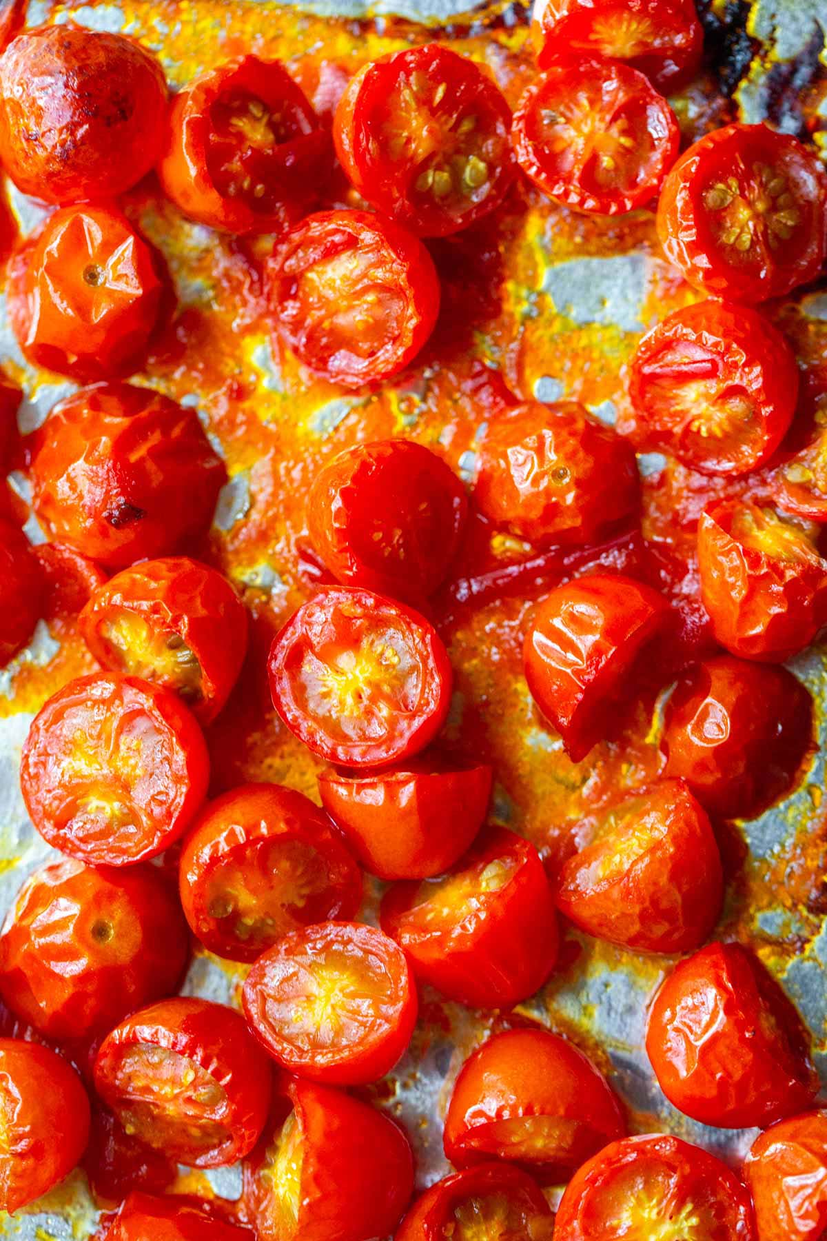 Roasted cherry tomatoes on a baking sheet.