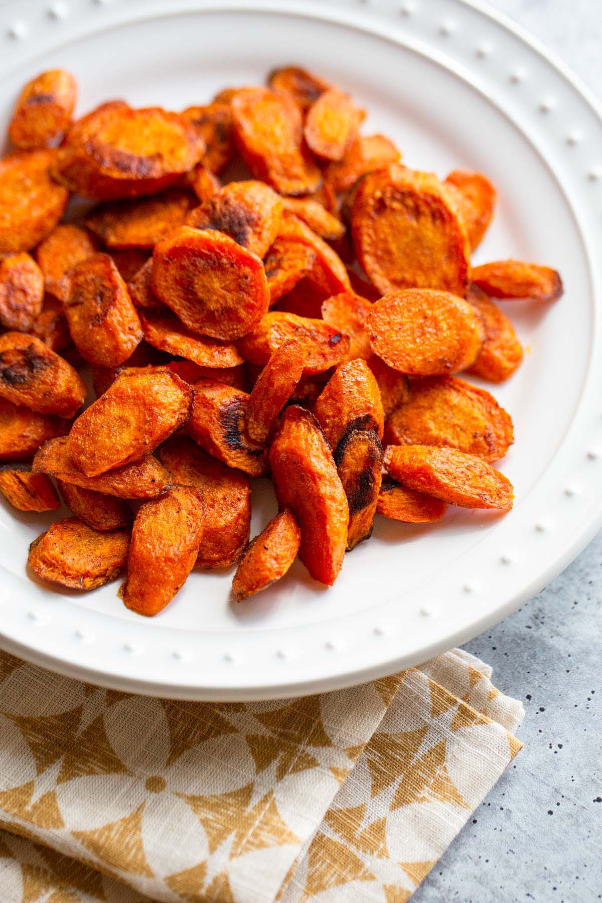 Roasted carrots on a white plate.