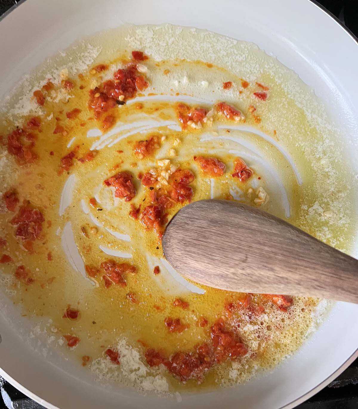 Making a calabrian sauce in a skillet.