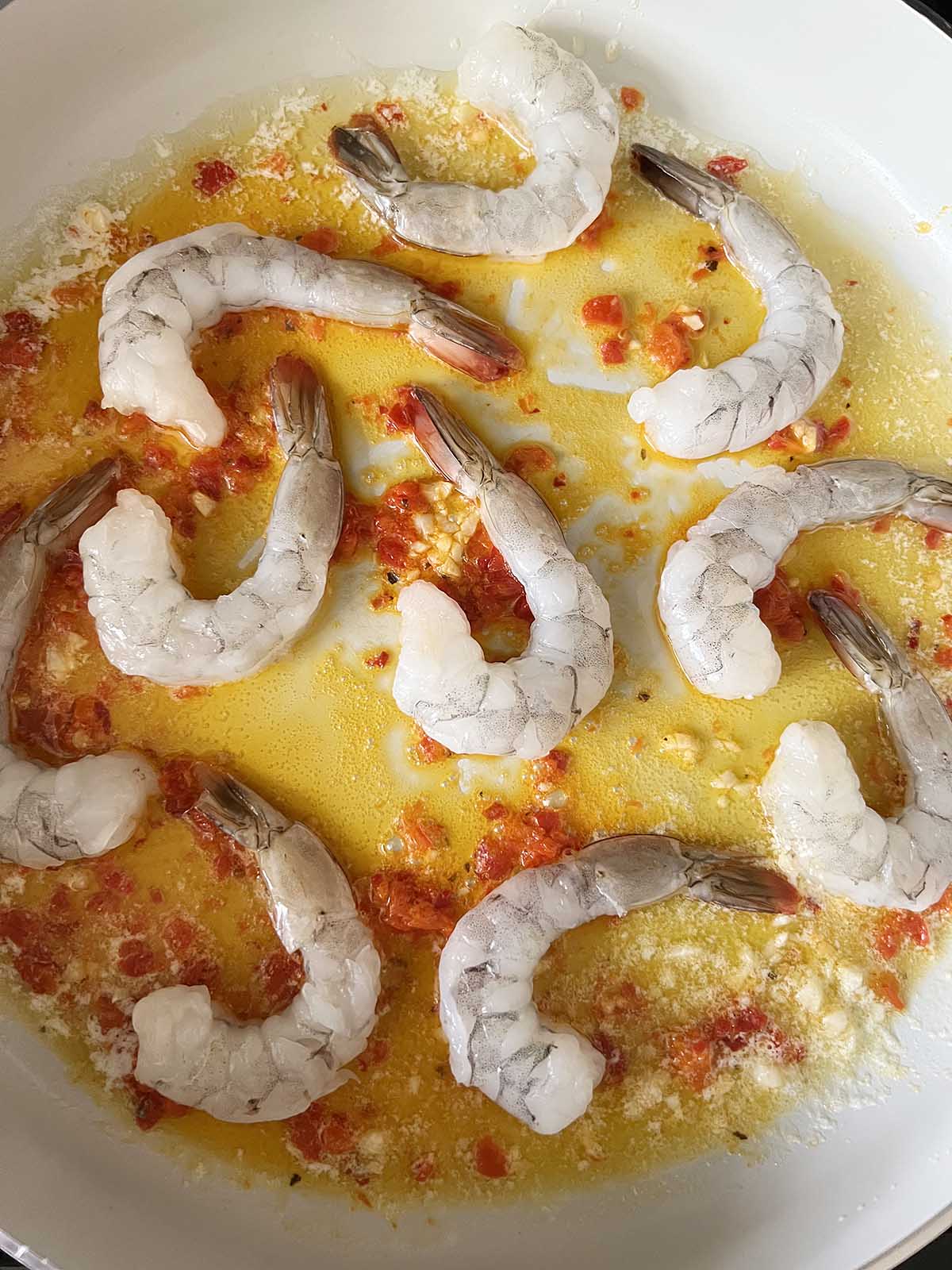 Shrimp cooking in a skillet.