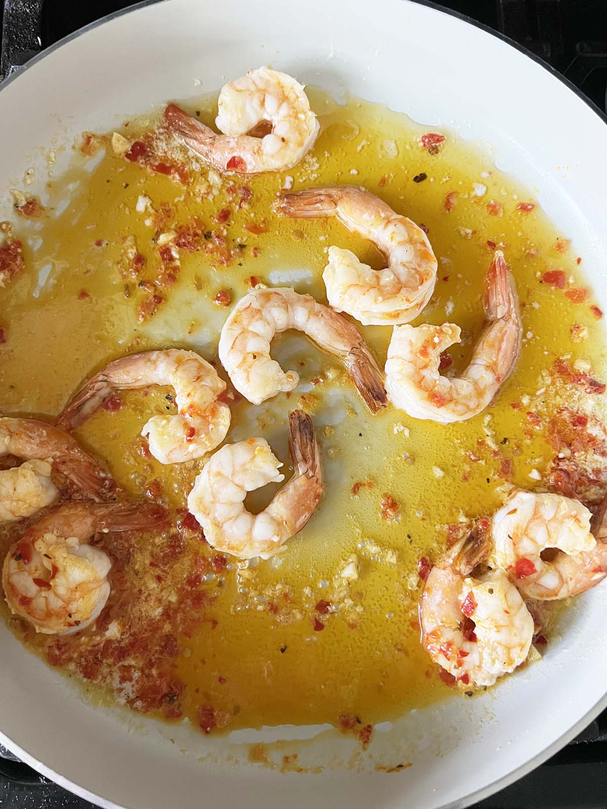 Shrimp cooking in a calabrian sauce.