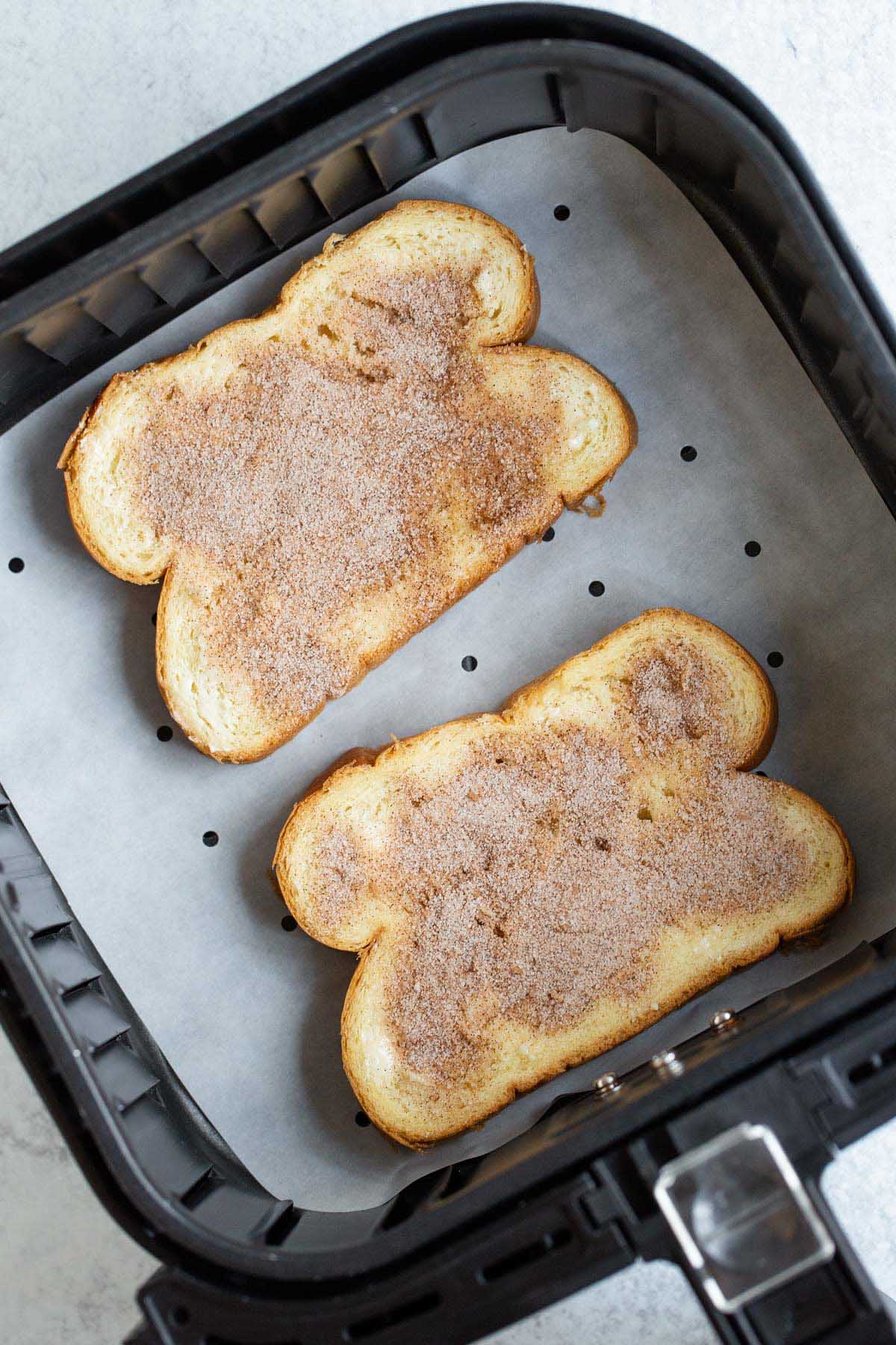 Uncooked cinnamon toast in air fryer basket.