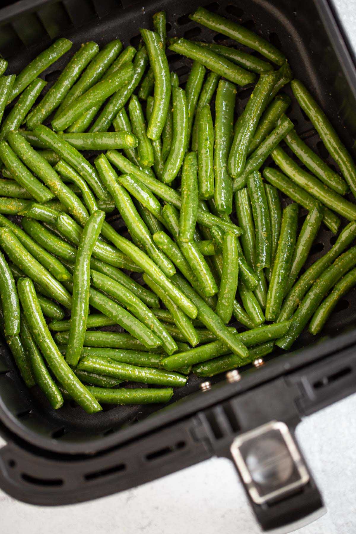 Green beans in air fryer basket.