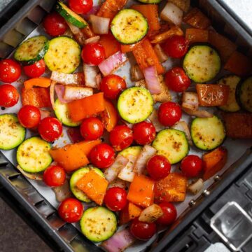 Air fryer vegetables in air fryer basket.