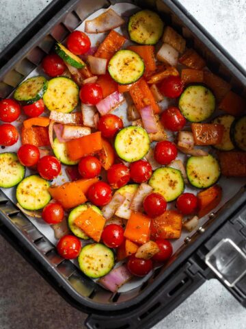 Air fryer vegetables in air fryer basket.