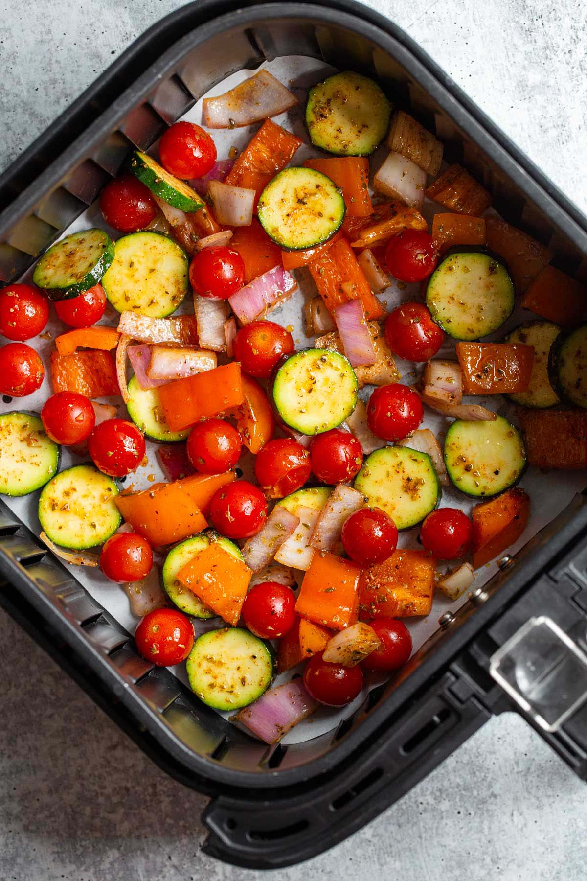 Air fryer vegetables in air fryer basket.