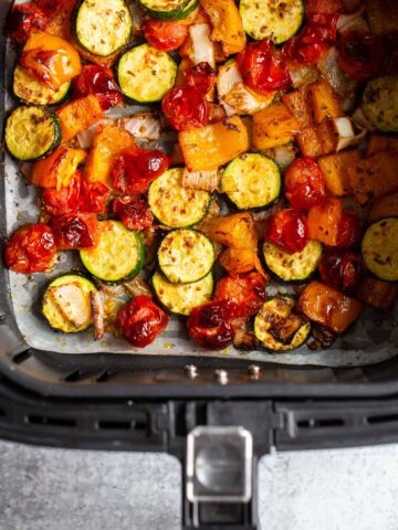 Air fryer vegetables in air fryer basket.