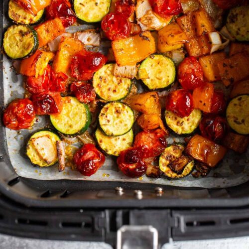 Air fryer vegetables in air fryer basket.