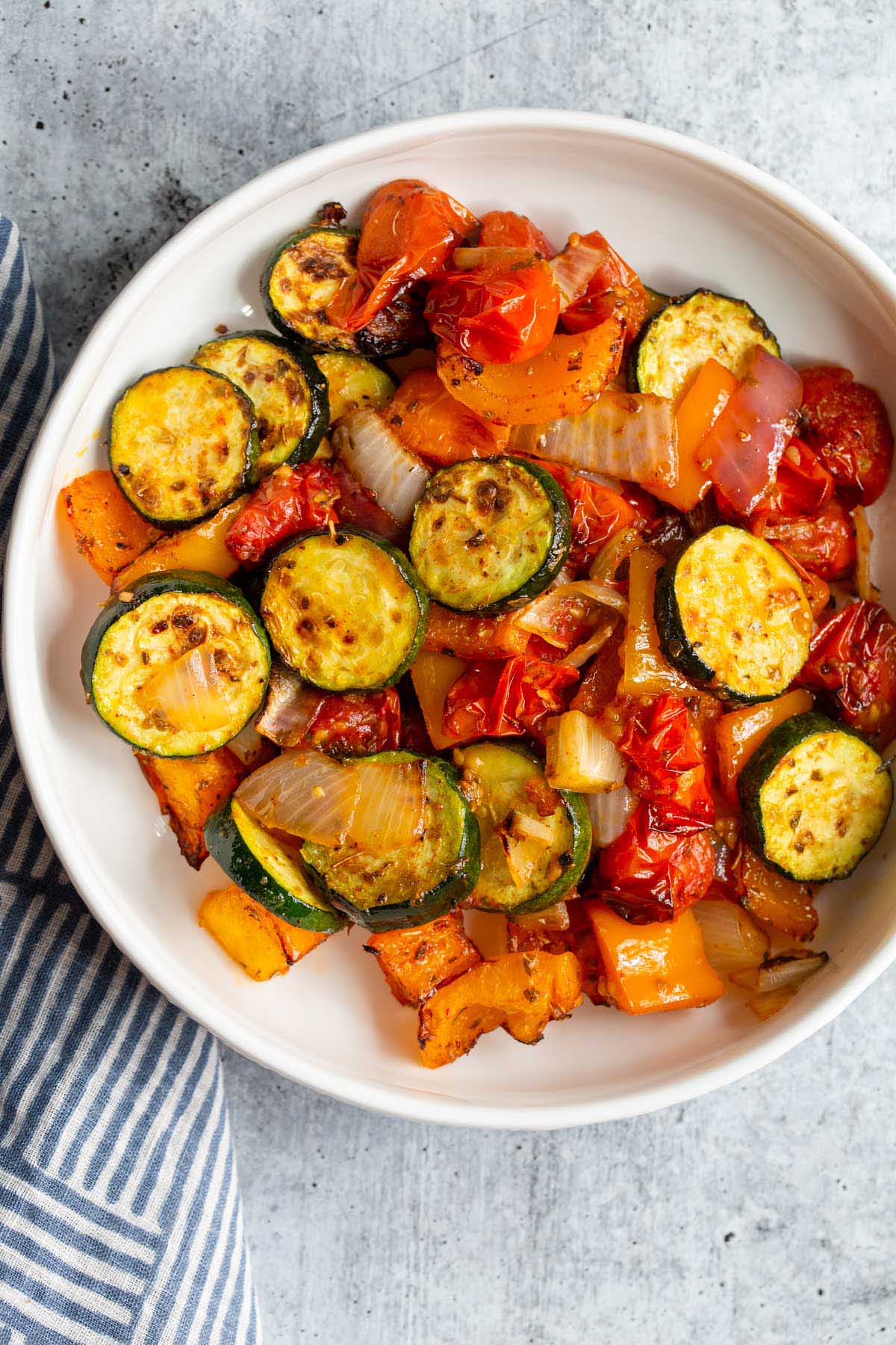 Air fried mediterranean vegetables in a white bowl.