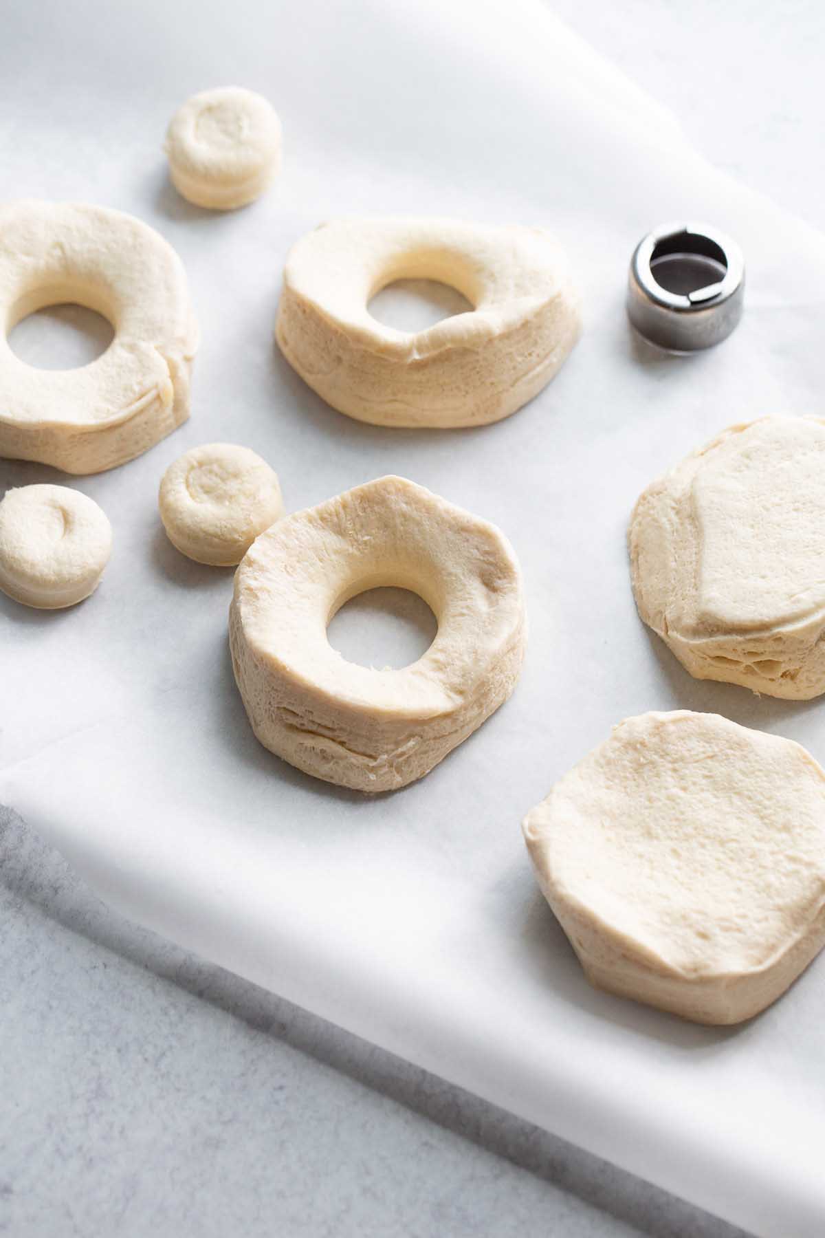 cutting holes in biscuits to make donuts