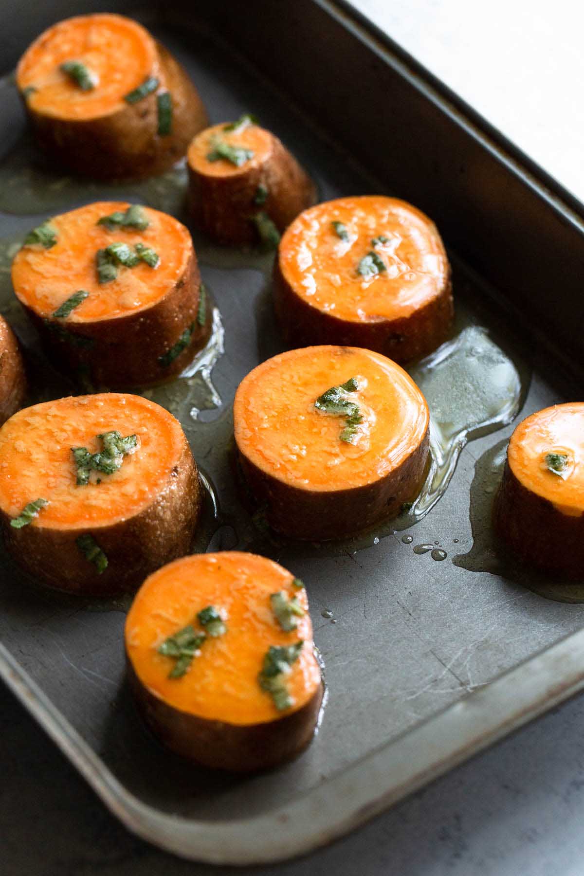 Uncooked sweet potatoes in a pan.