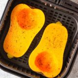 Uncooked butternut squash in air fryer.