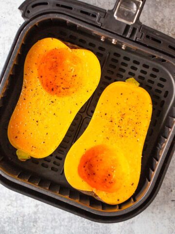 Uncooked butternut squash in air fryer.