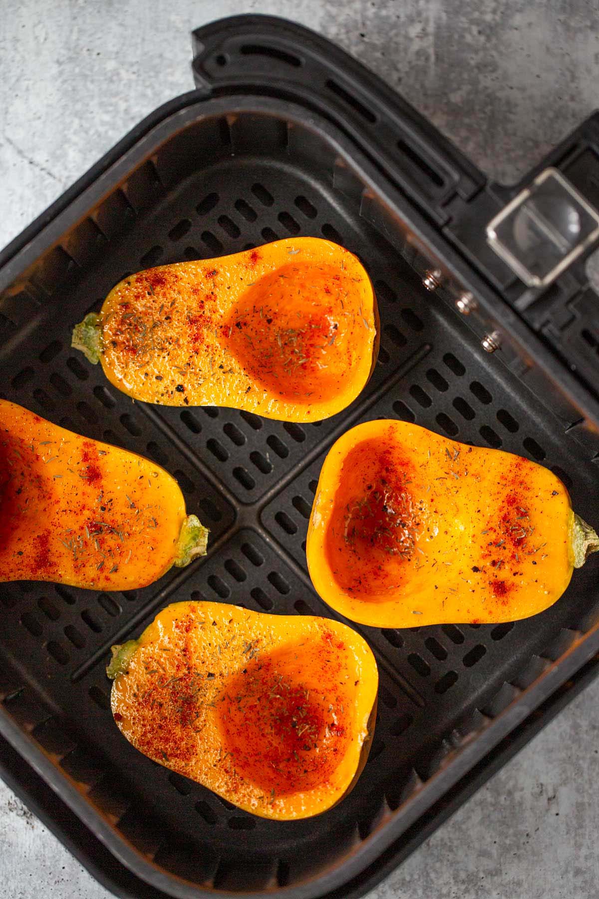 Honeynut squash in air fryer basket.