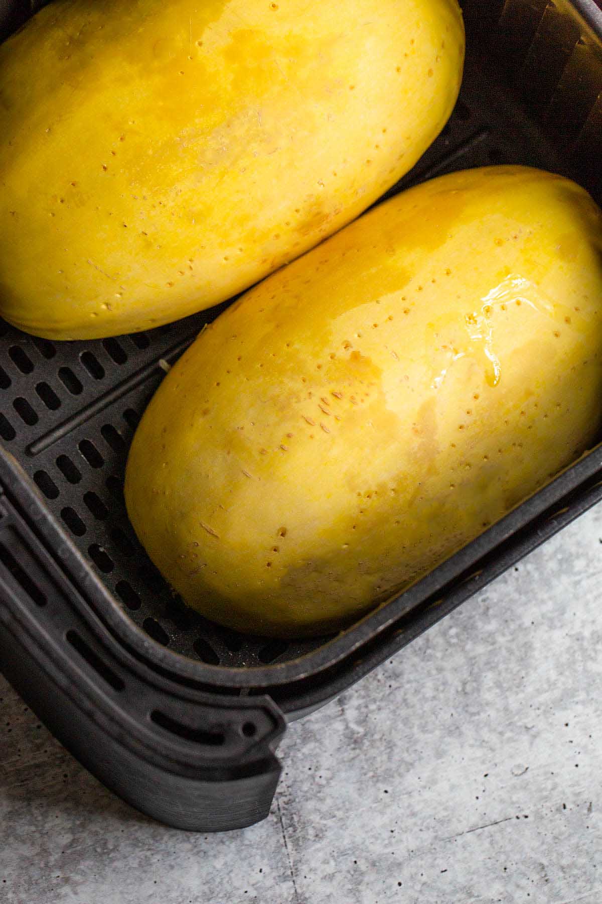 Cut spaghetti squash in air fryer basket.