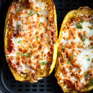 Cheesy spaghetti squash in air fryer basket.