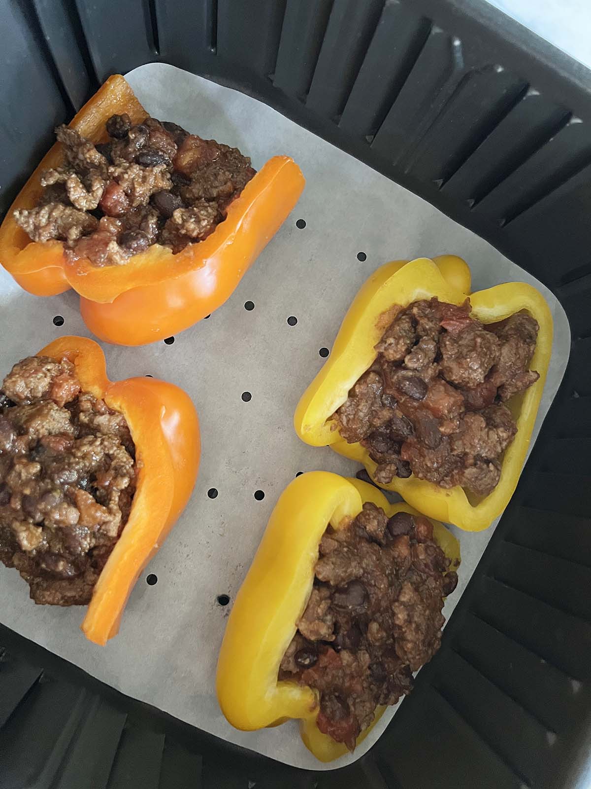 Stuffing bell peppers with meat and beans.