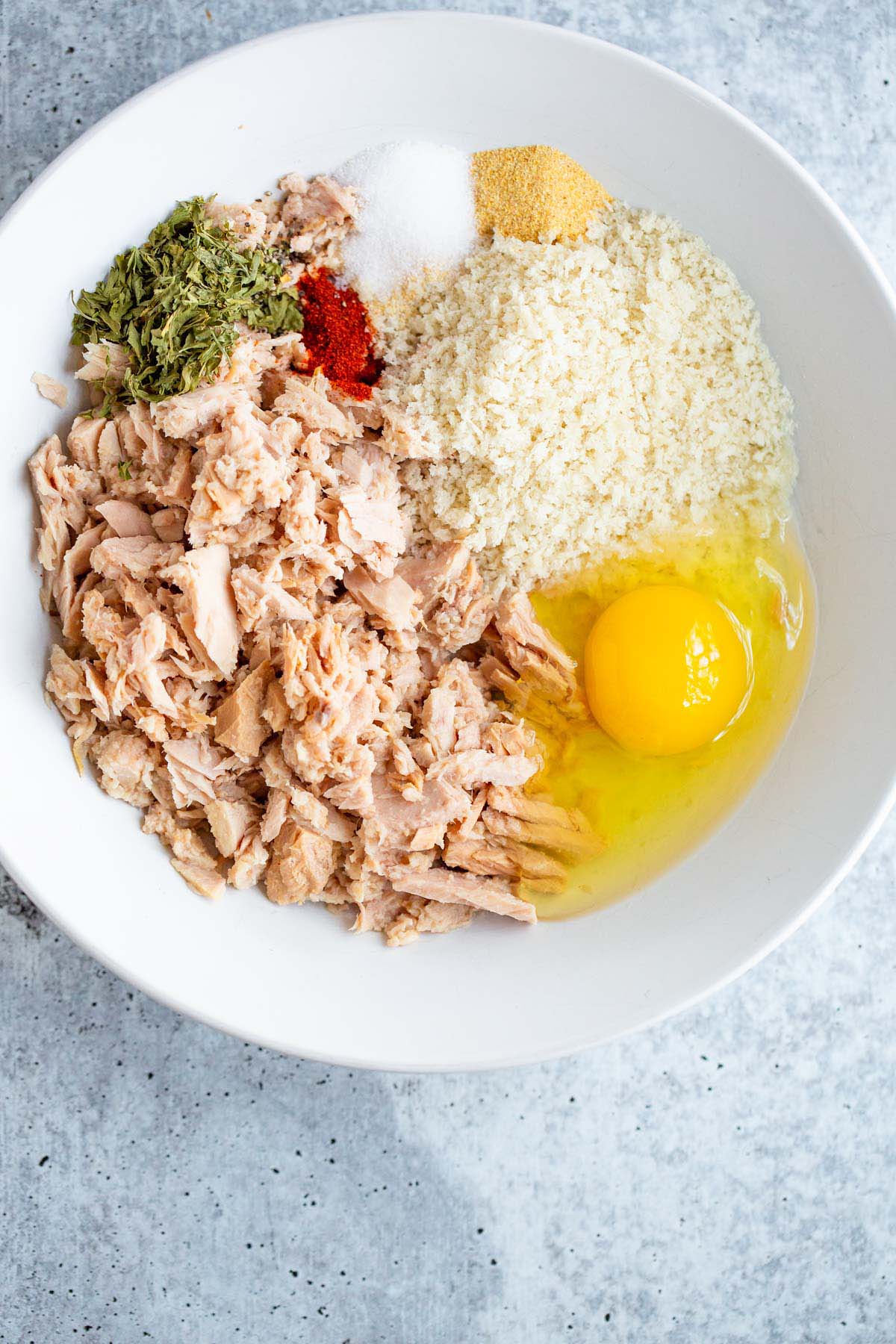Tuna, egg, panko, and seasonings in a bowl.