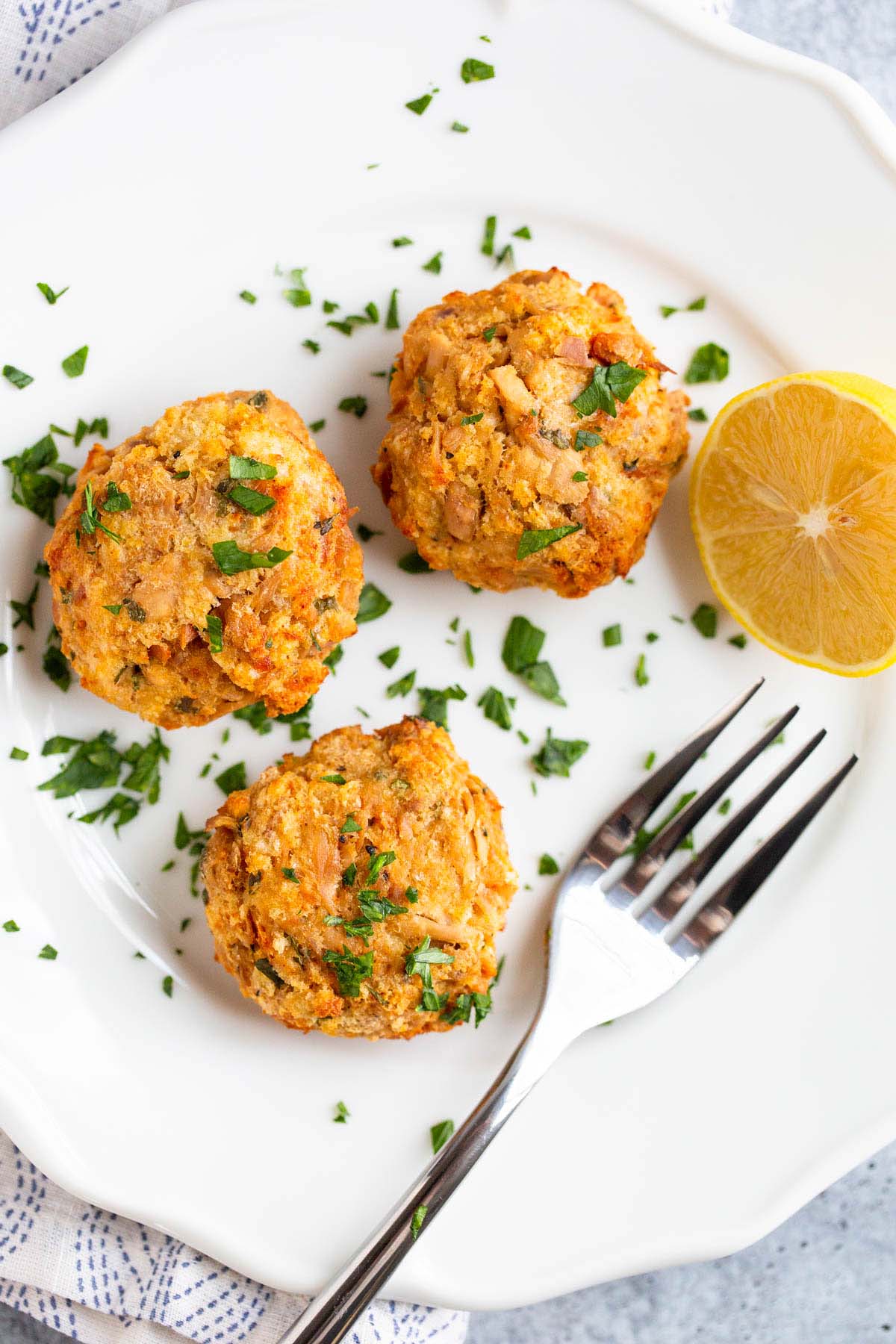 Tuna patties on a plate with fresh parsley.