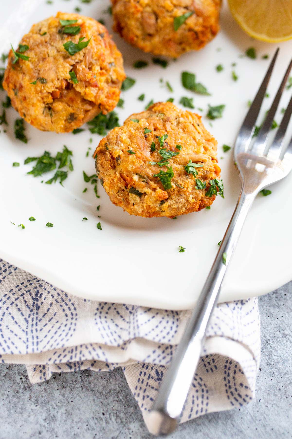 Tuna patties on a plate with fresh parsley.