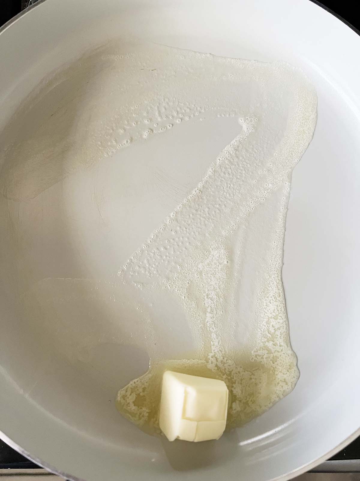 Melting butter in the pan.