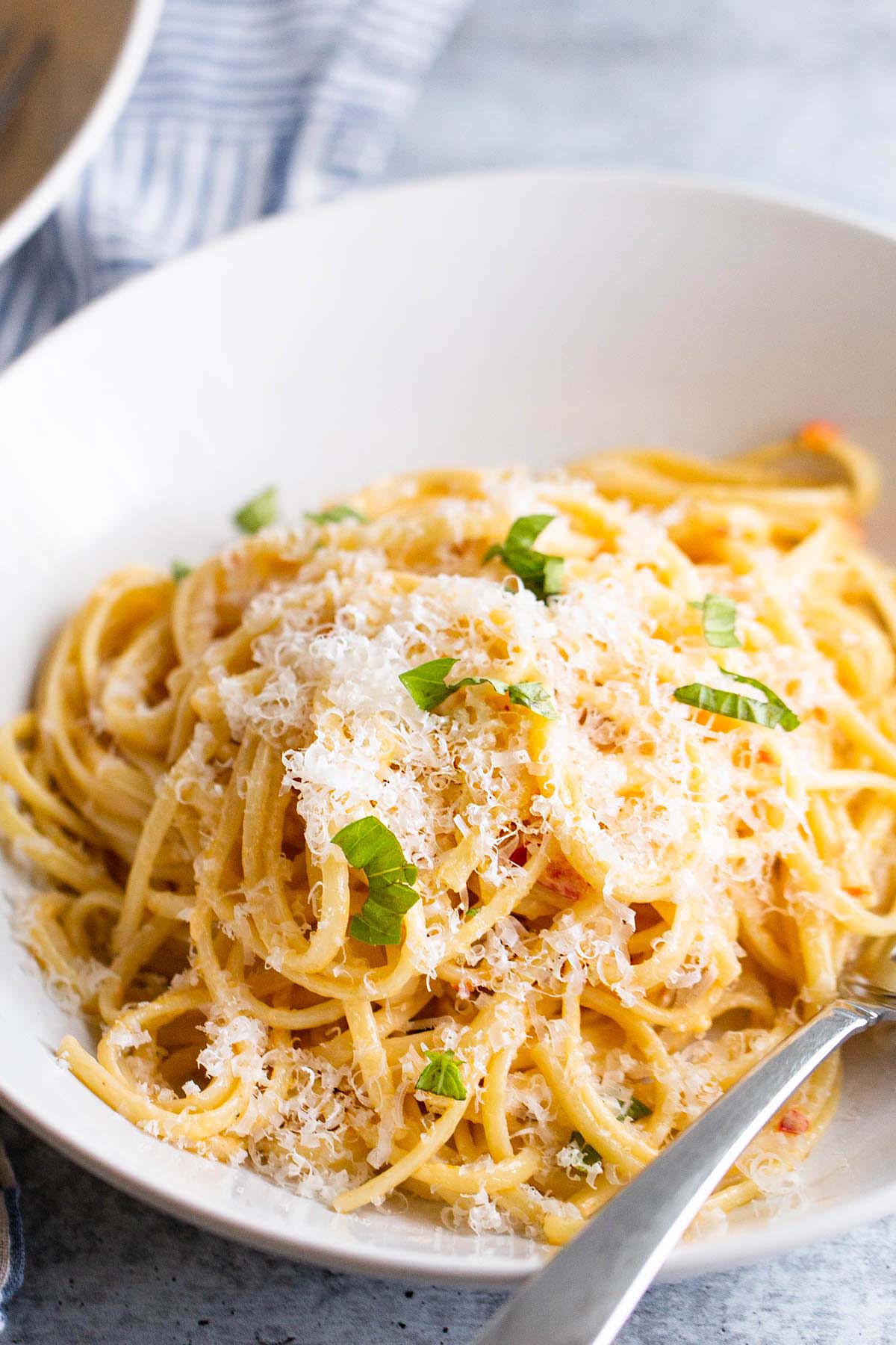 Creamy calabrian pasta topped with cheese and herbs.