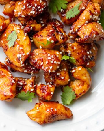 Honey sriracha chicken bites with sesame seeds up close