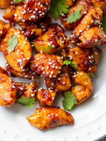Honey sriracha chicken bites with sesame seeds up close