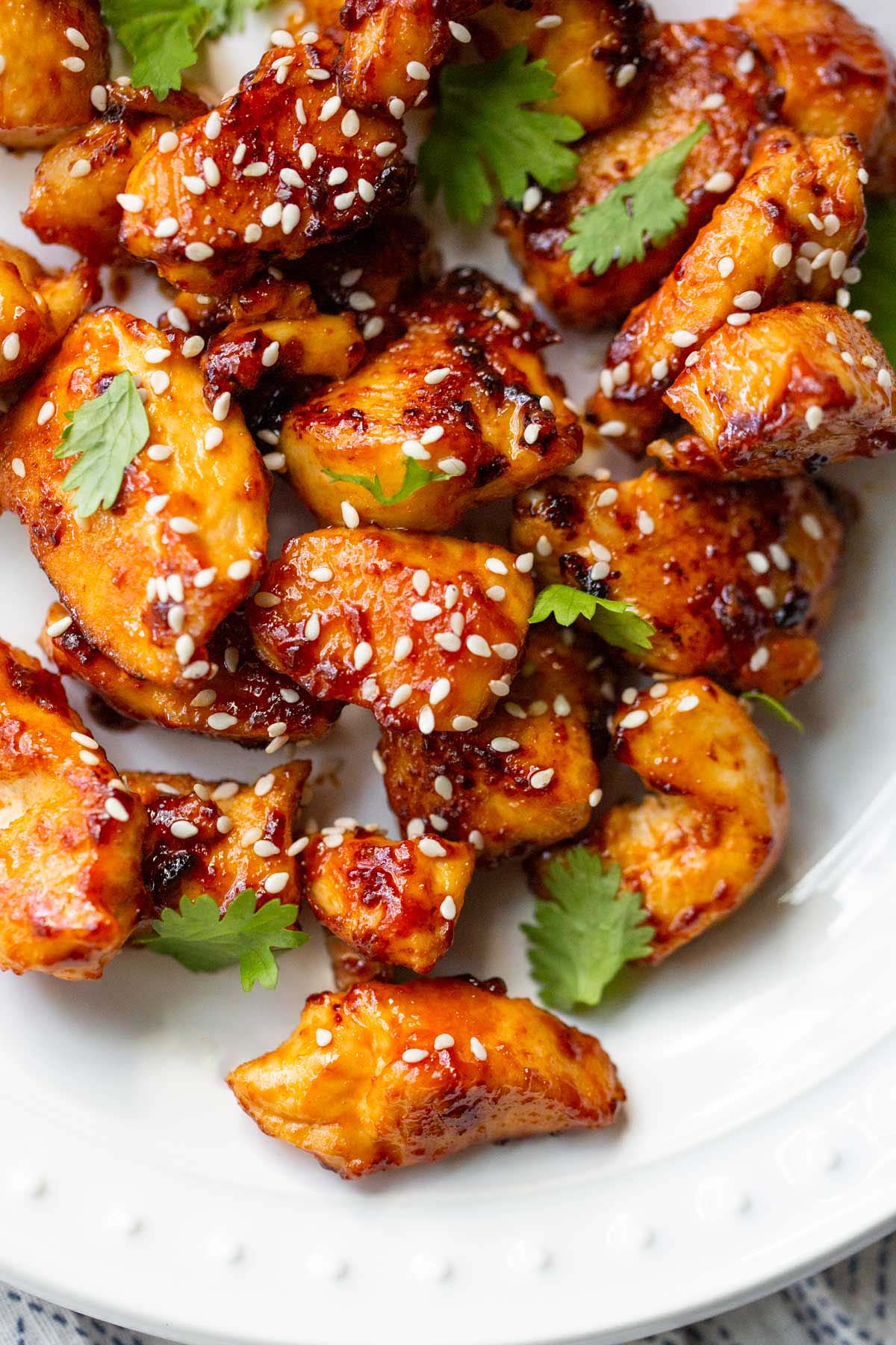 Honey sriracha chicken bites with sesame seeds up close