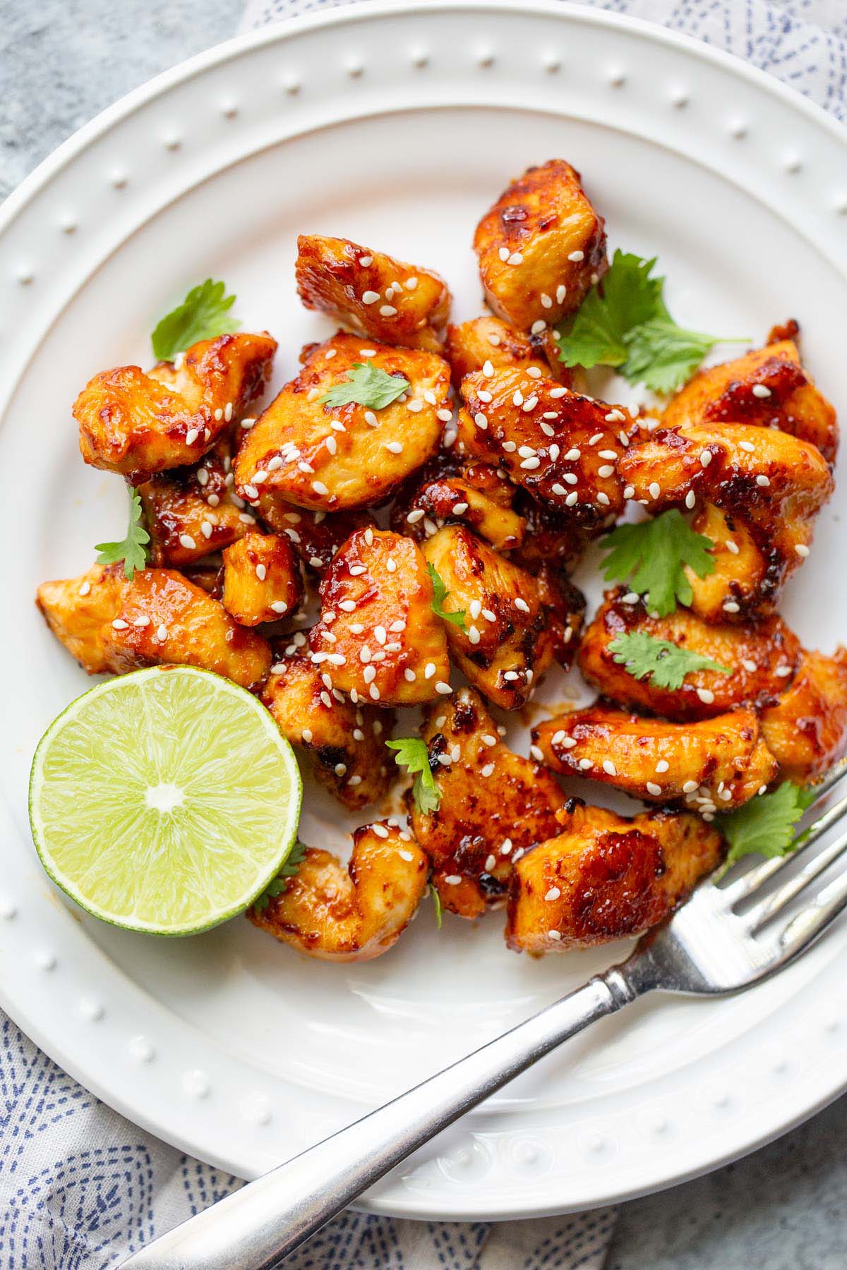 Honey sriracha chicken bites with sesame seeds and cilantro