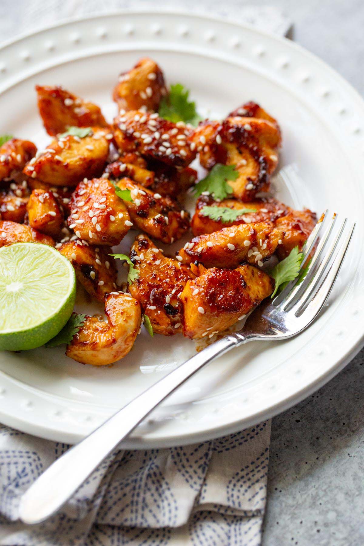 Honey sriracha chicken bites with sesame seeds and cilantro