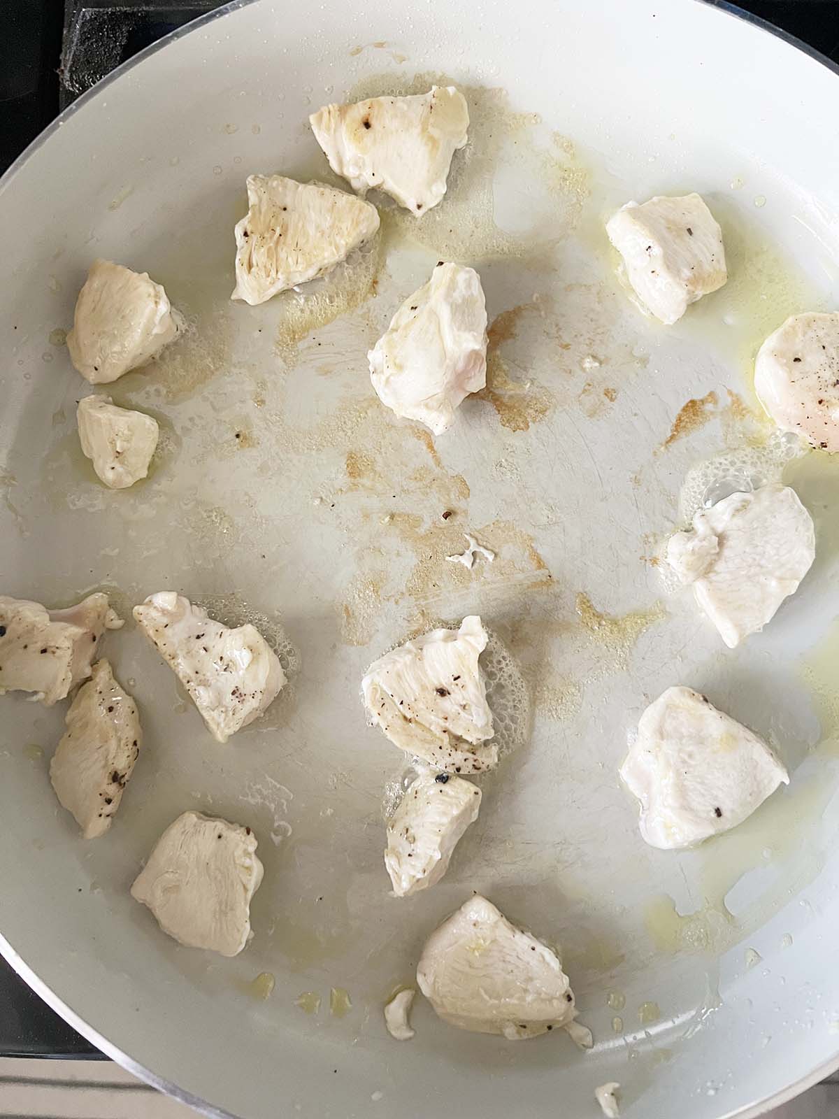 Chicken cooking in a skillet