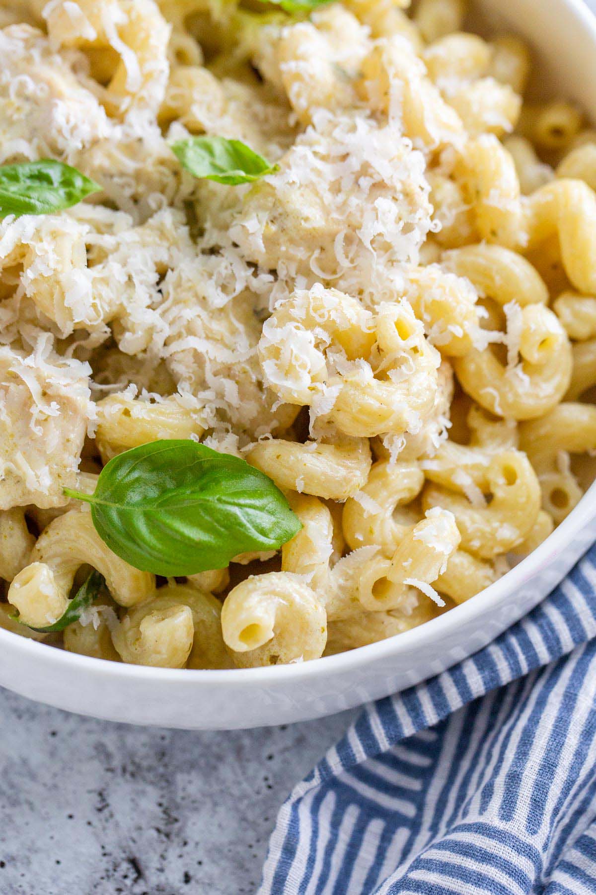 Creamy pesto cavatappi with parmesan cheese and basil leaves