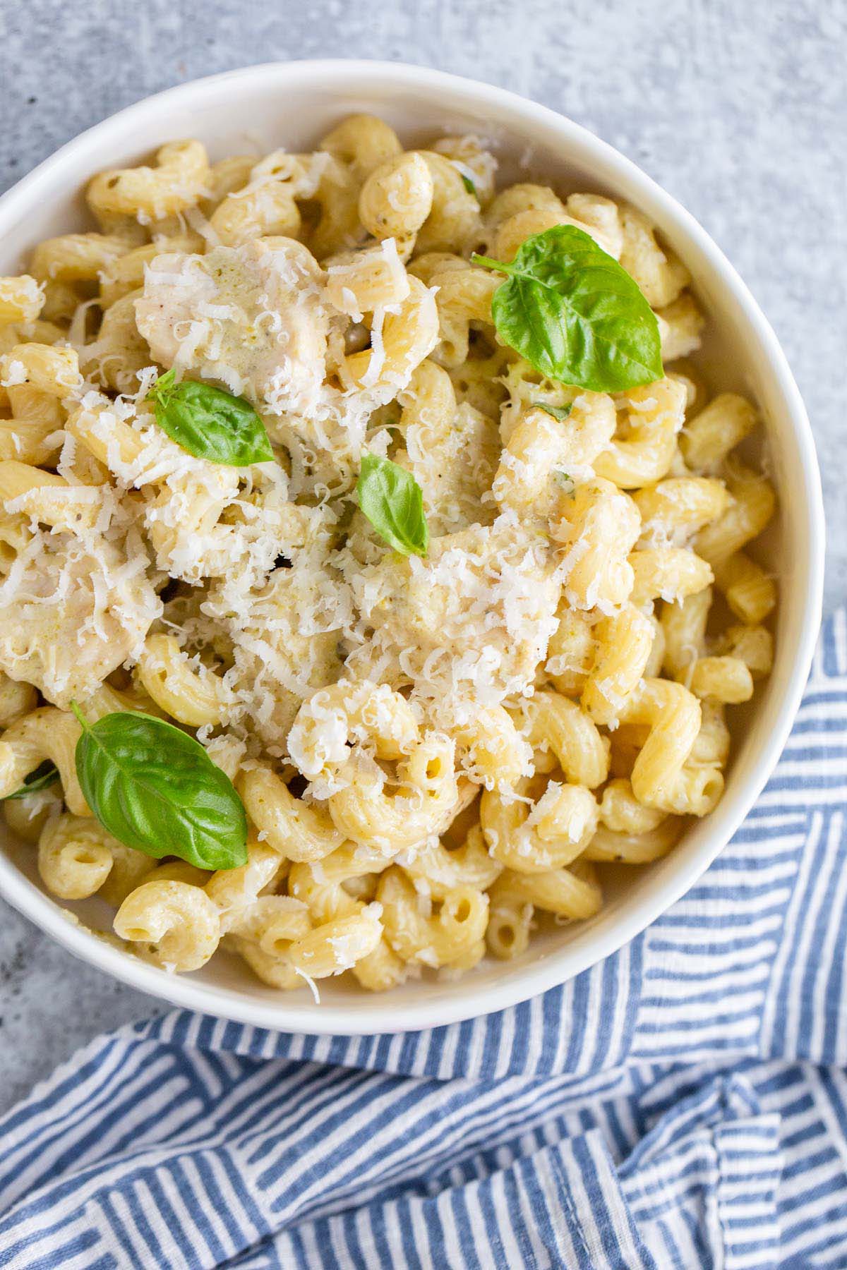 Creamy pesto cavatappi with parmesan cheese and basil leaves
