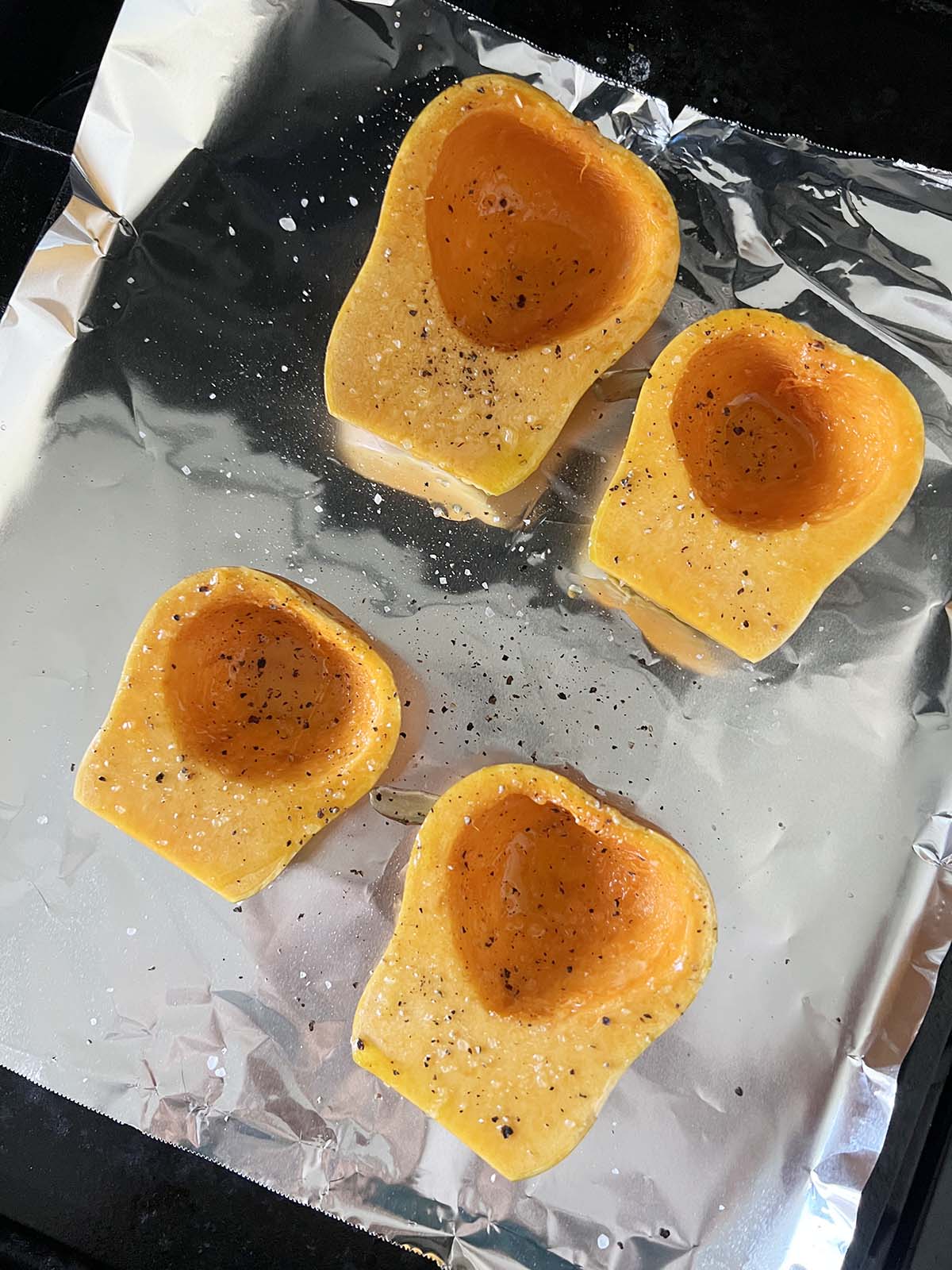 Uncooked squash on a baking sheet.