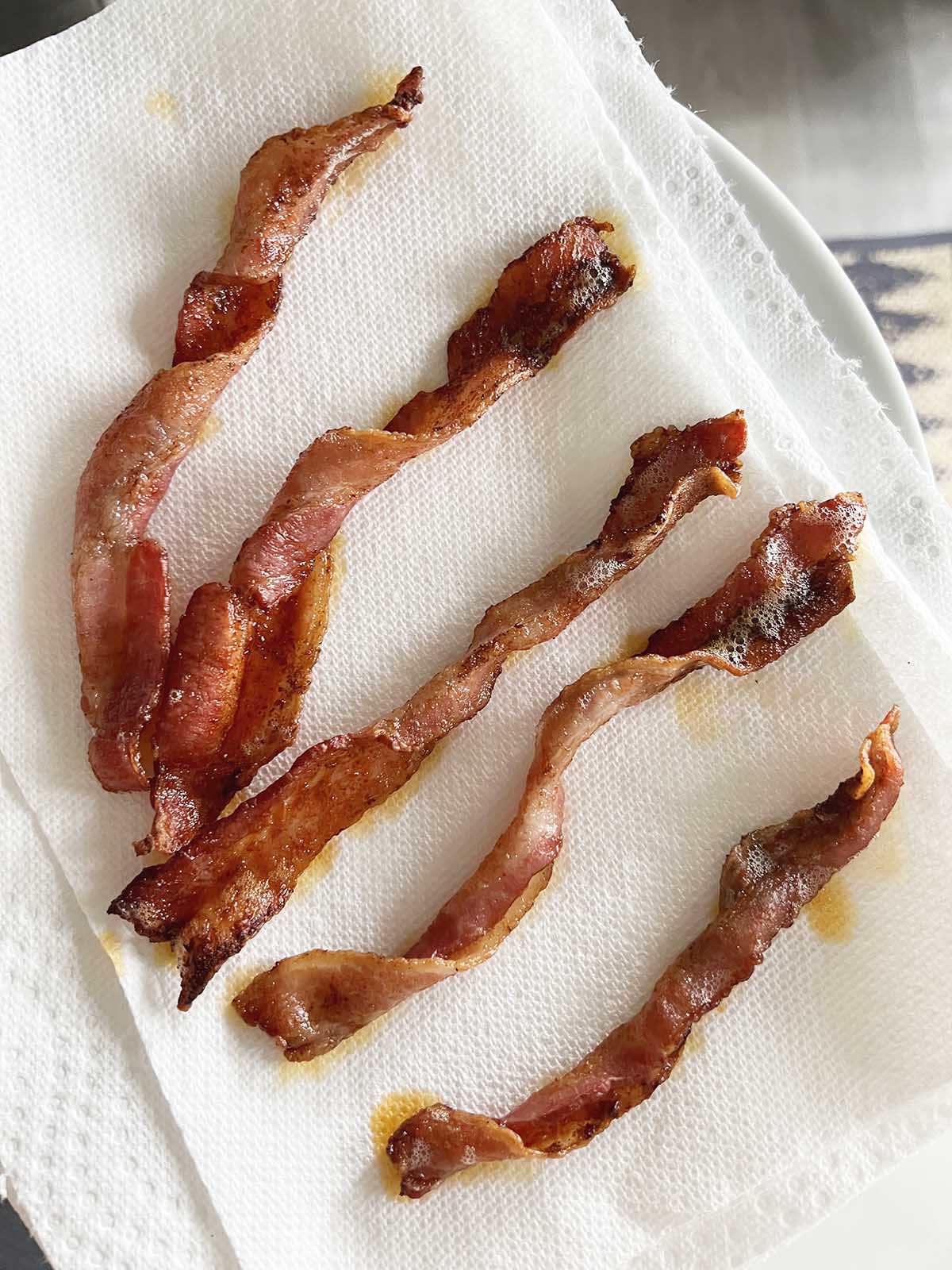 Bacon twists on paper towels.