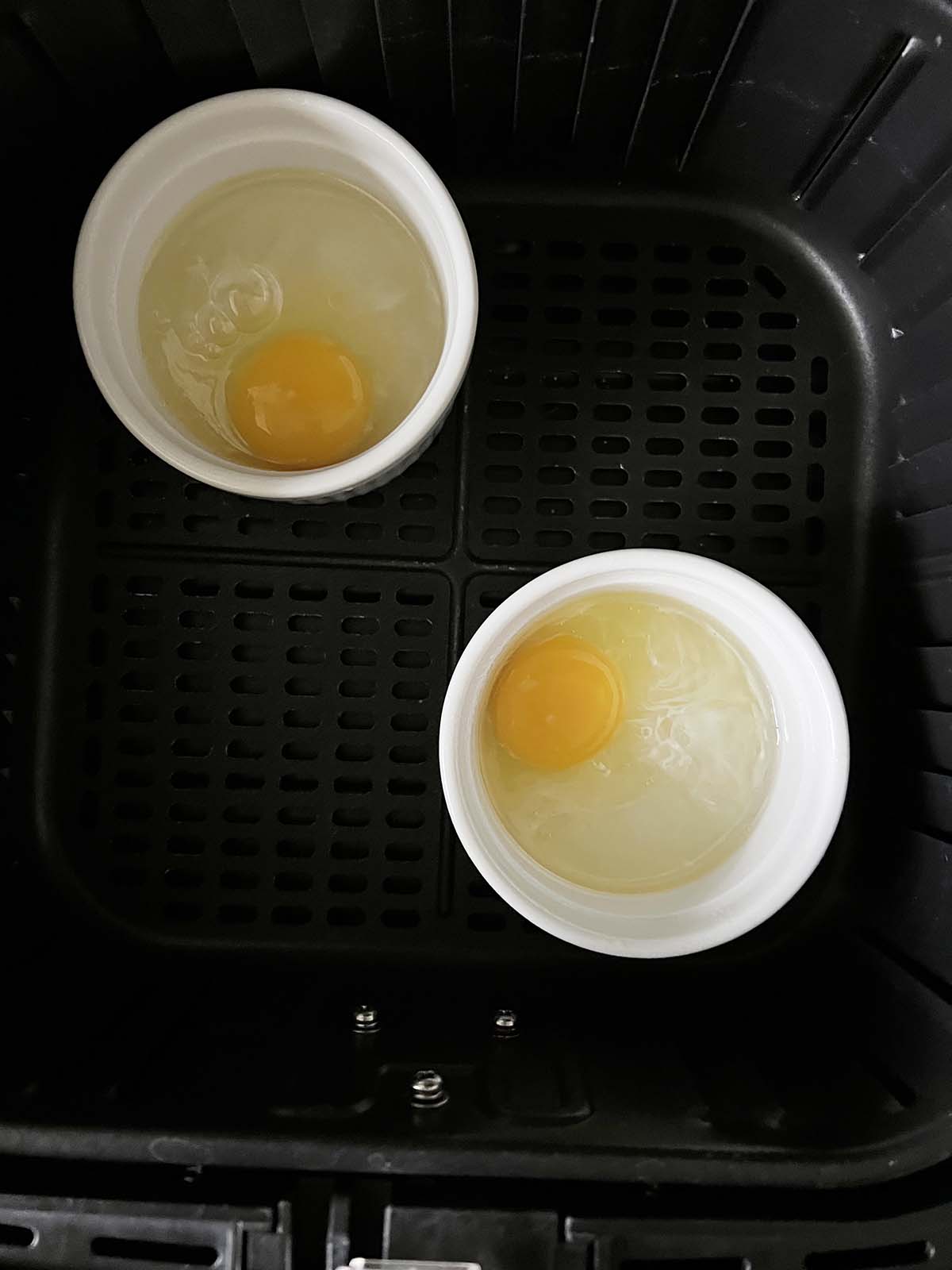 Raw eggs in ramekins.