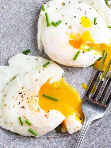 Air fryer poached eggs topped with chives.